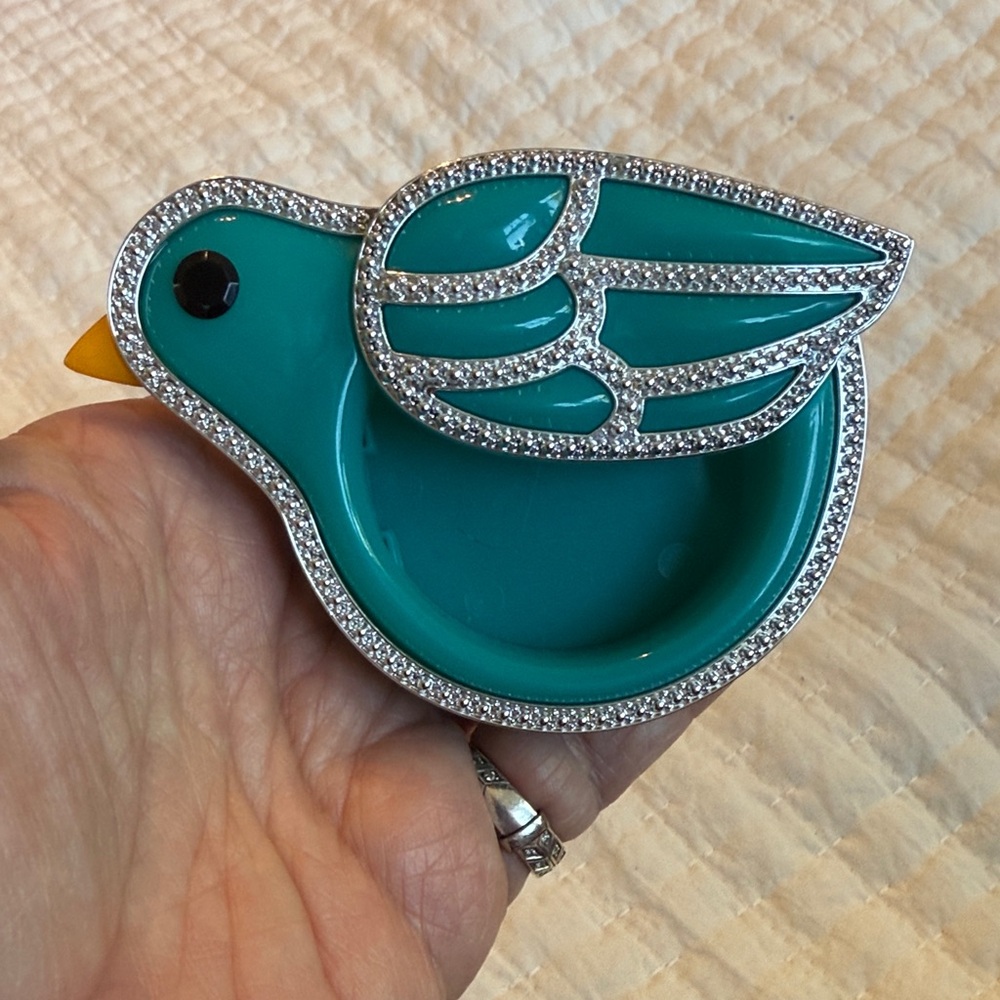 Bath & Body Works teal bird car fragrance holder with silver accents.